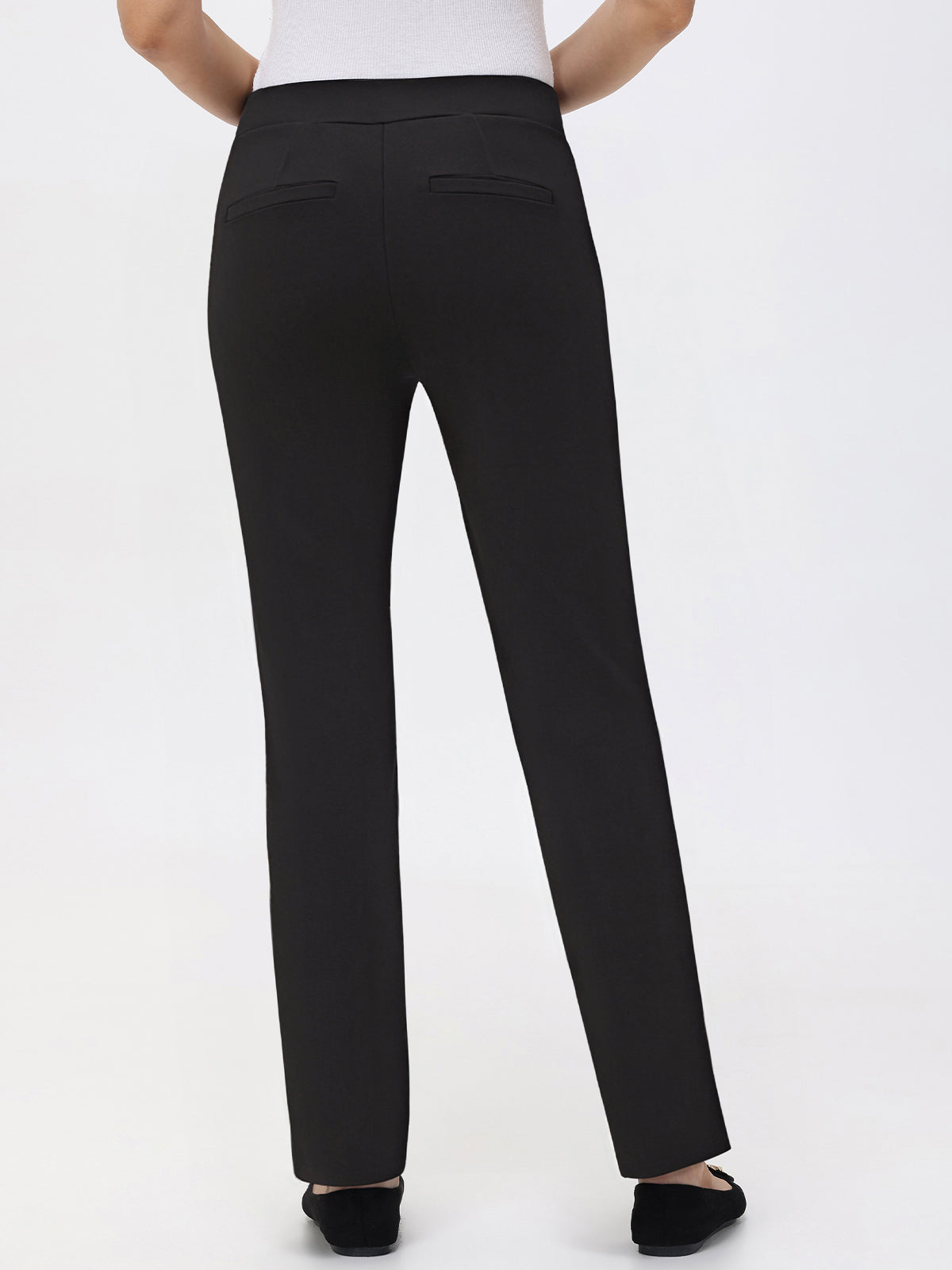 Black pants worn by a person on a white background