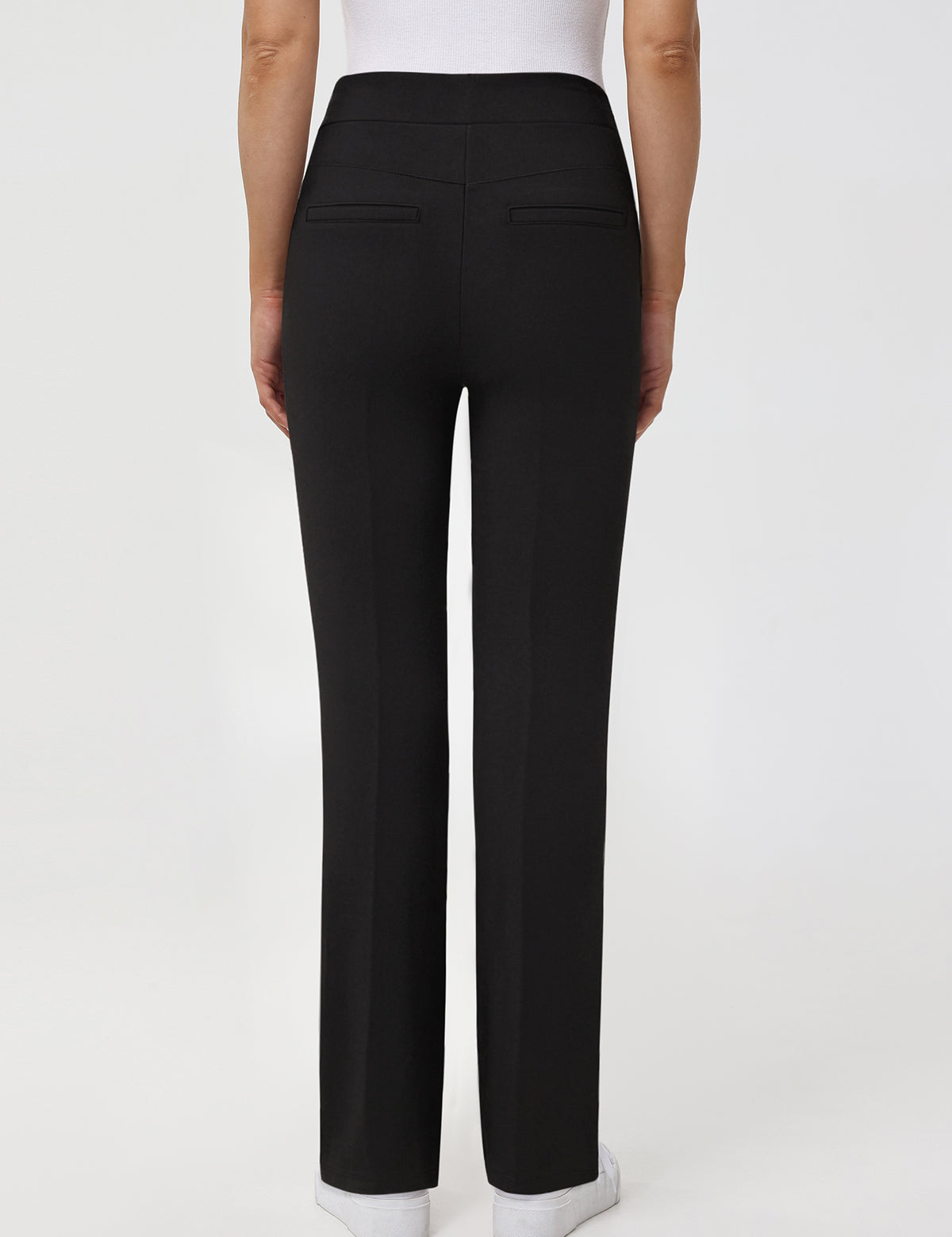 Black pants worn by a person on a white background