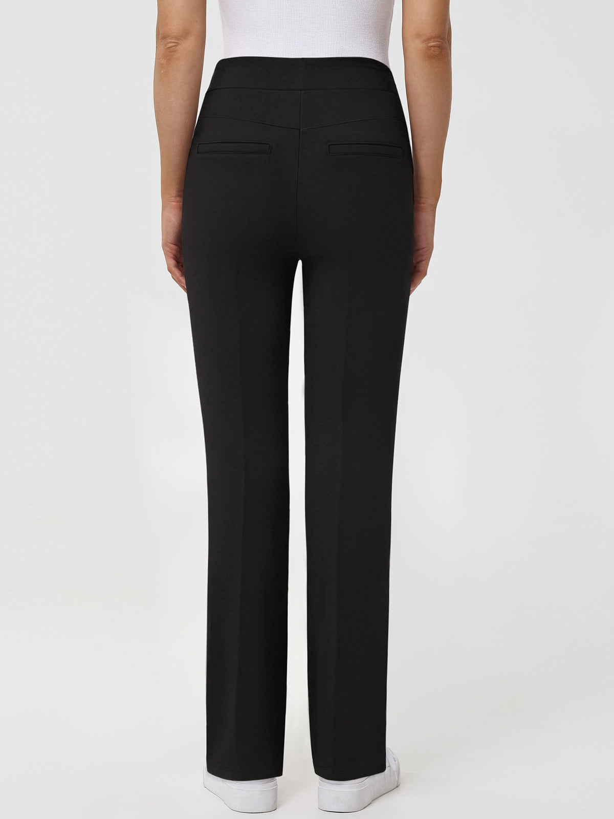 Black pants worn by a person on a white background