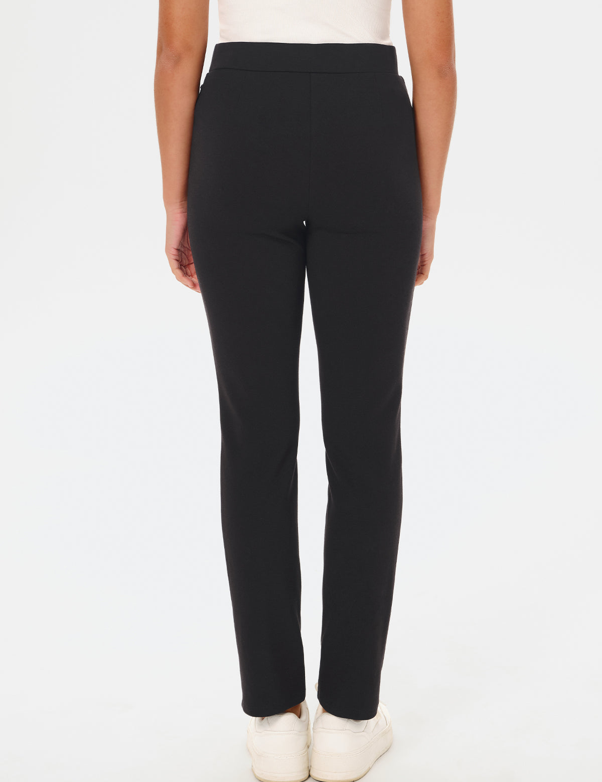 Black pants worn by a person on a white background