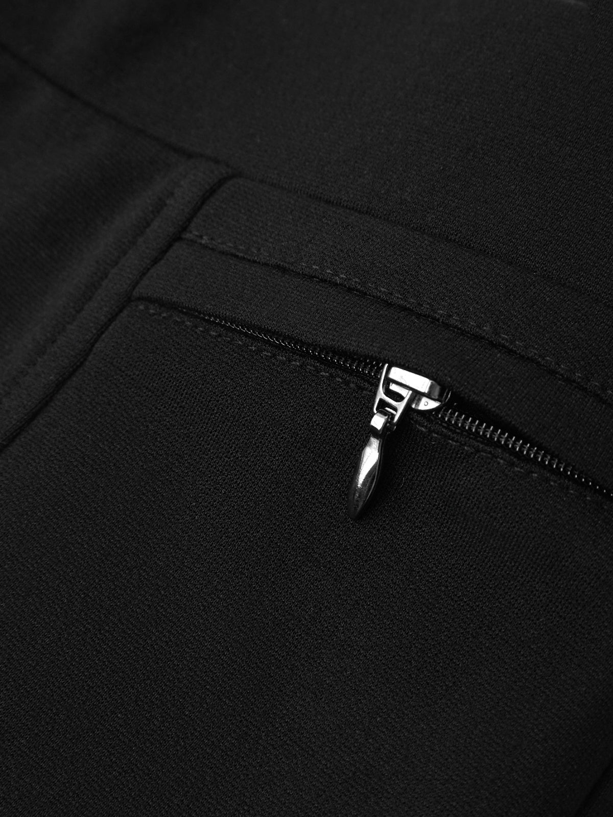 Close-up of a black zipper on a black background