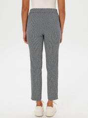 Person wearing gray patterned pants on a white background