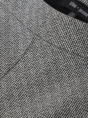 Close-up of a textured gray fabric with a brand label in the corner.