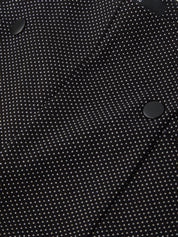 Close-up of a black fabric with white polka dots