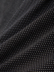 Close-up of black fabric with white polka dots