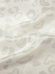 Close-up of a textured fabric with abstract pattern on a light background