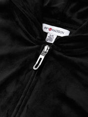 Close-up of a black jacket with a zipper and 8th Madison label.