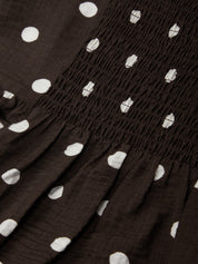 Black fabric with white polka dots