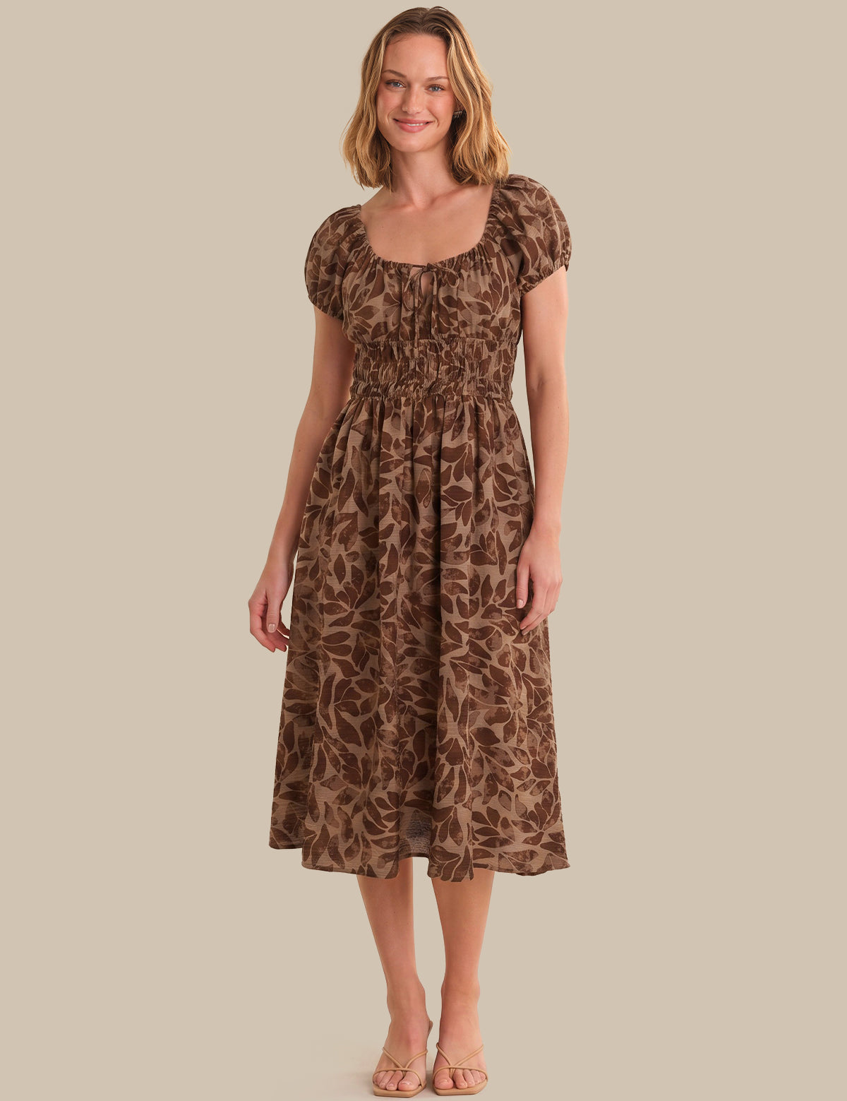Woman wearing a brown leopard print dress against a beige background