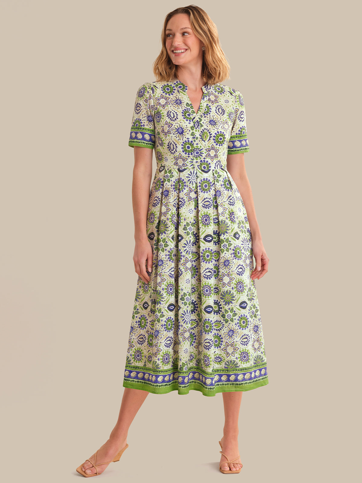Woman wearing a floral dress on a beige background