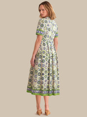 Woman wearing a patterned dress on a beige background