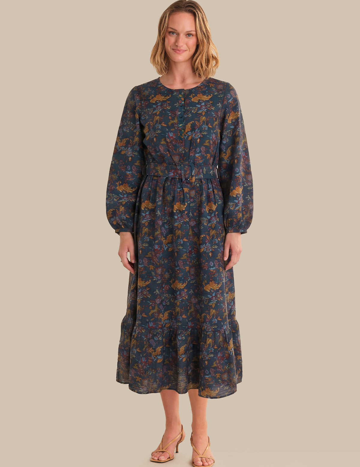 Woman wearing a floral dress on a beige background