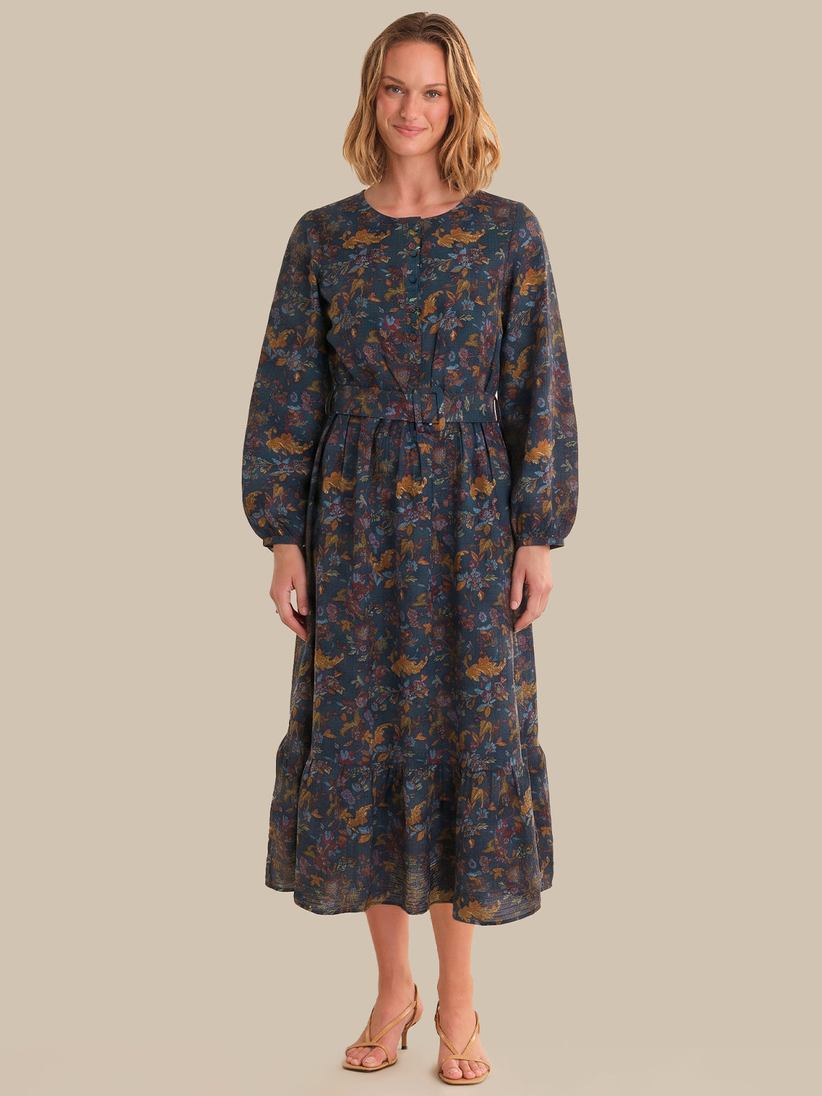 Woman wearing a floral dress on a beige background