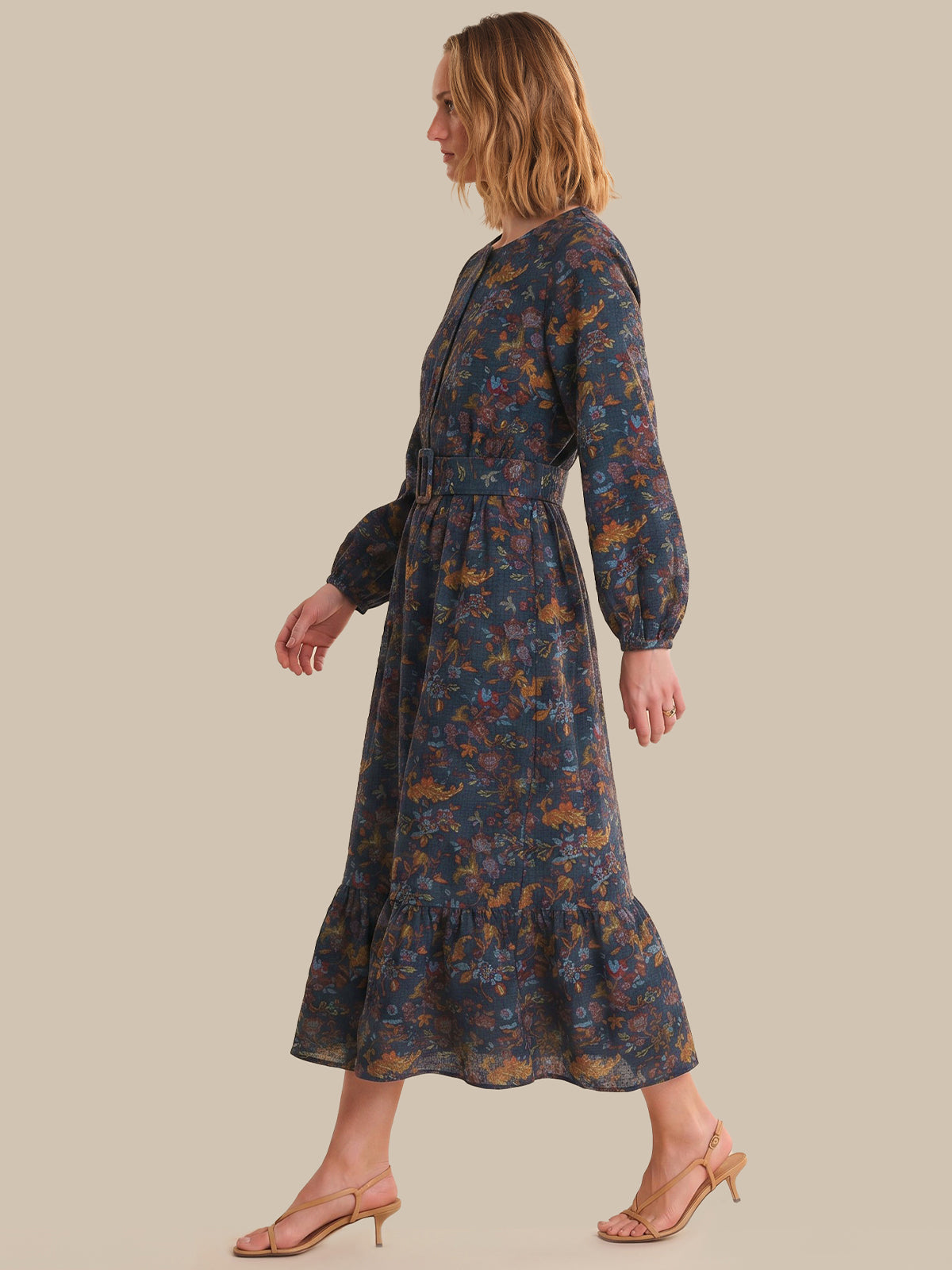 Woman wearing a floral dress on a beige background