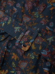Floral patterned fabric with a button detail on a dark background