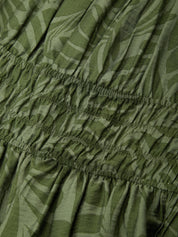 Close-up of green patterned fabric with an elastic waistband