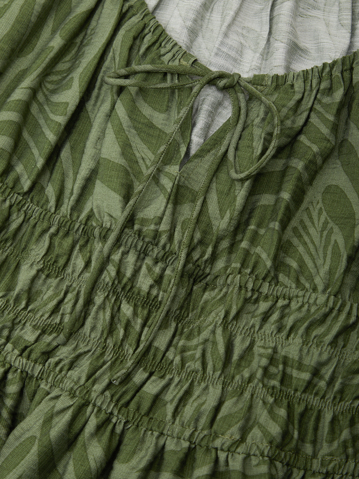 Close-up of green patterned fabric with a drawstring waist.