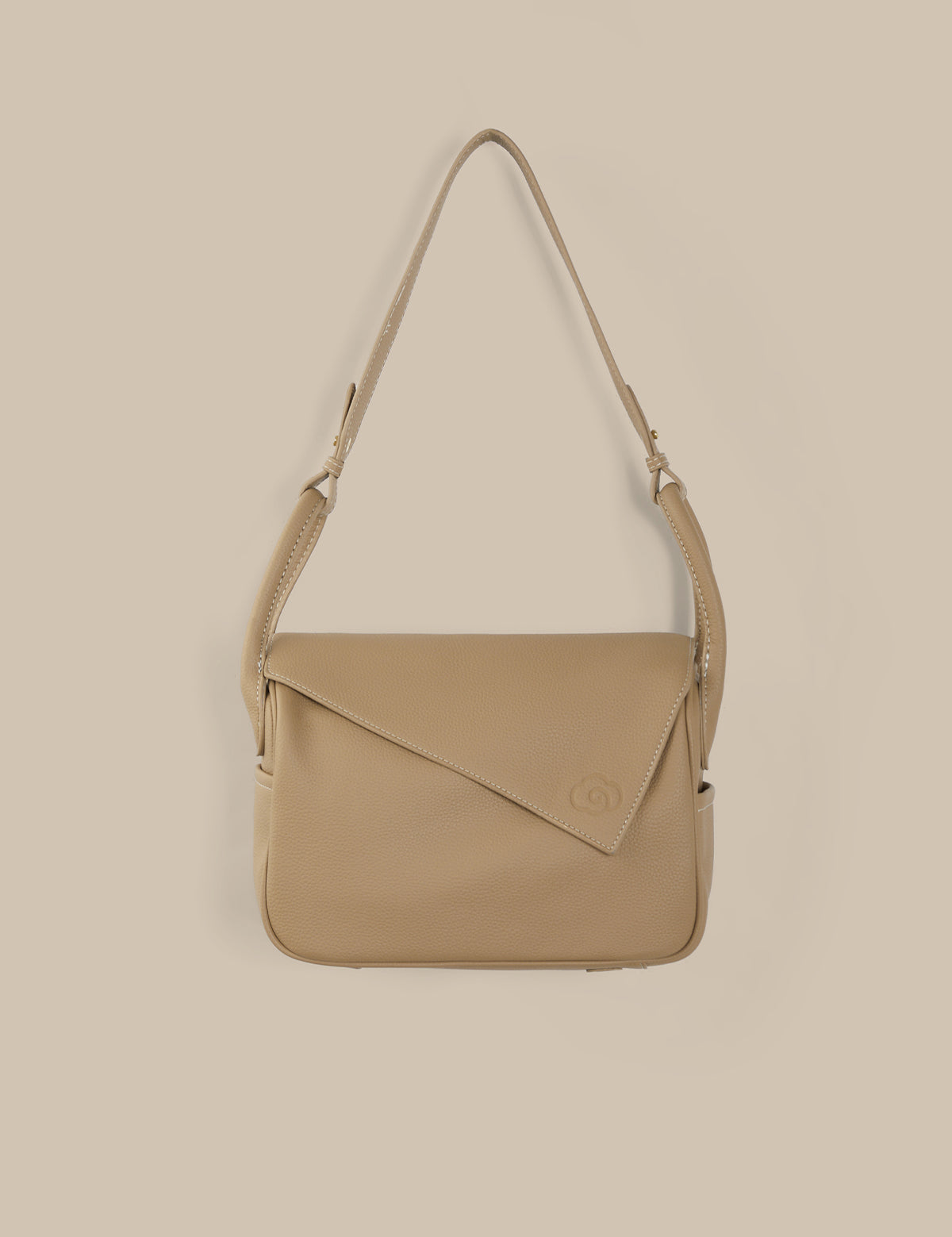 Beige shoulder bag on a beige background
