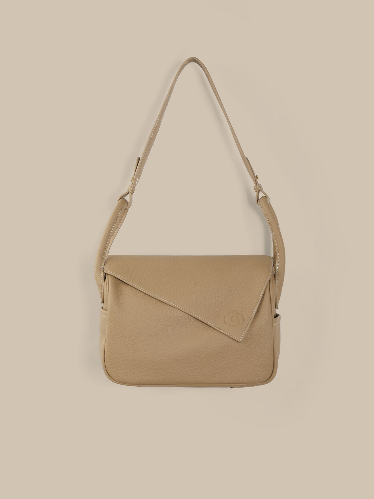 Beige shoulder bag on a beige background