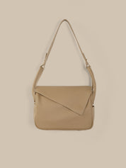 Beige shoulder bag on a beige background