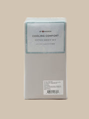 A boxed fitted sheet set by 8Y MADISON, labeled 'COOLING COMFORT FITTED SHEET SET,' shown upright against a plain warm beige background.