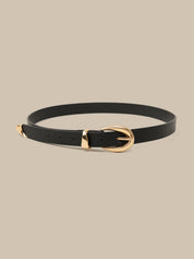 Black belt with a gold buckle on a beige background