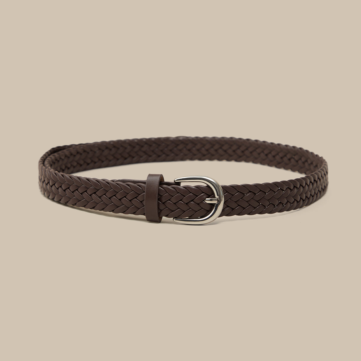 Brown braided belt with a silver buckle on a beige background