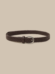 Brown braided belt with a silver buckle on a beige background