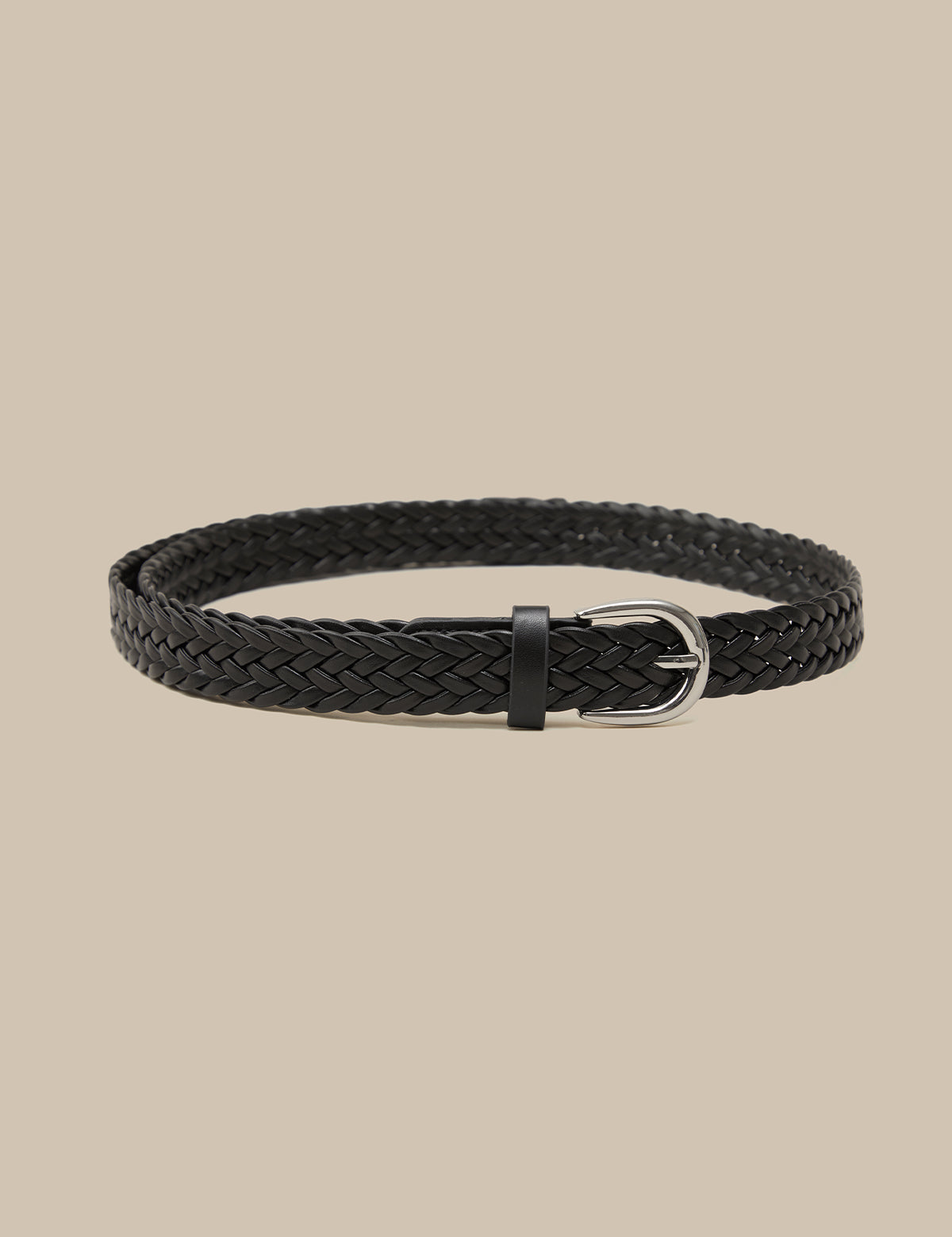 Black braided belt on a beige background