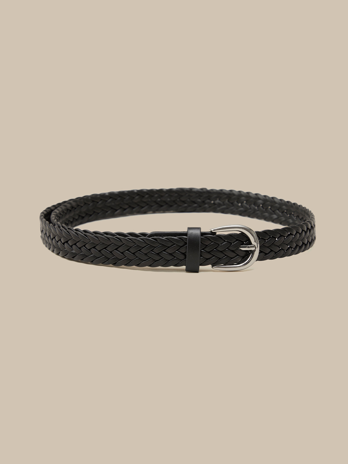 Black braided belt on a beige background
