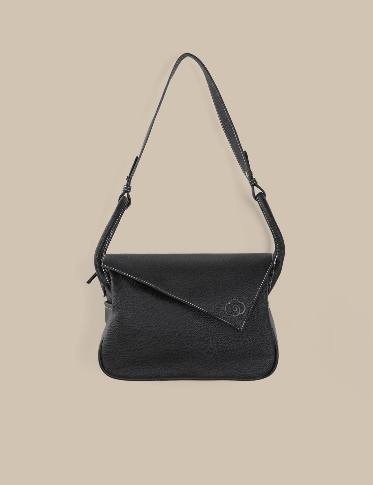 Black shoulder bag on a beige background