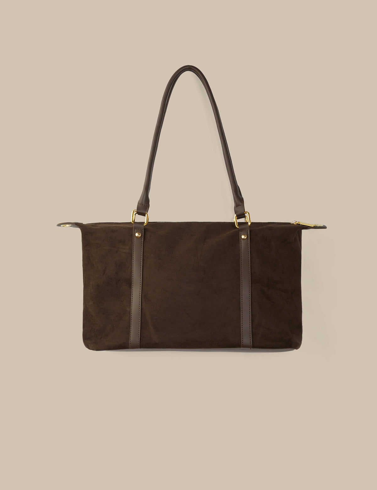 Brown handbag with black straps on a beige background