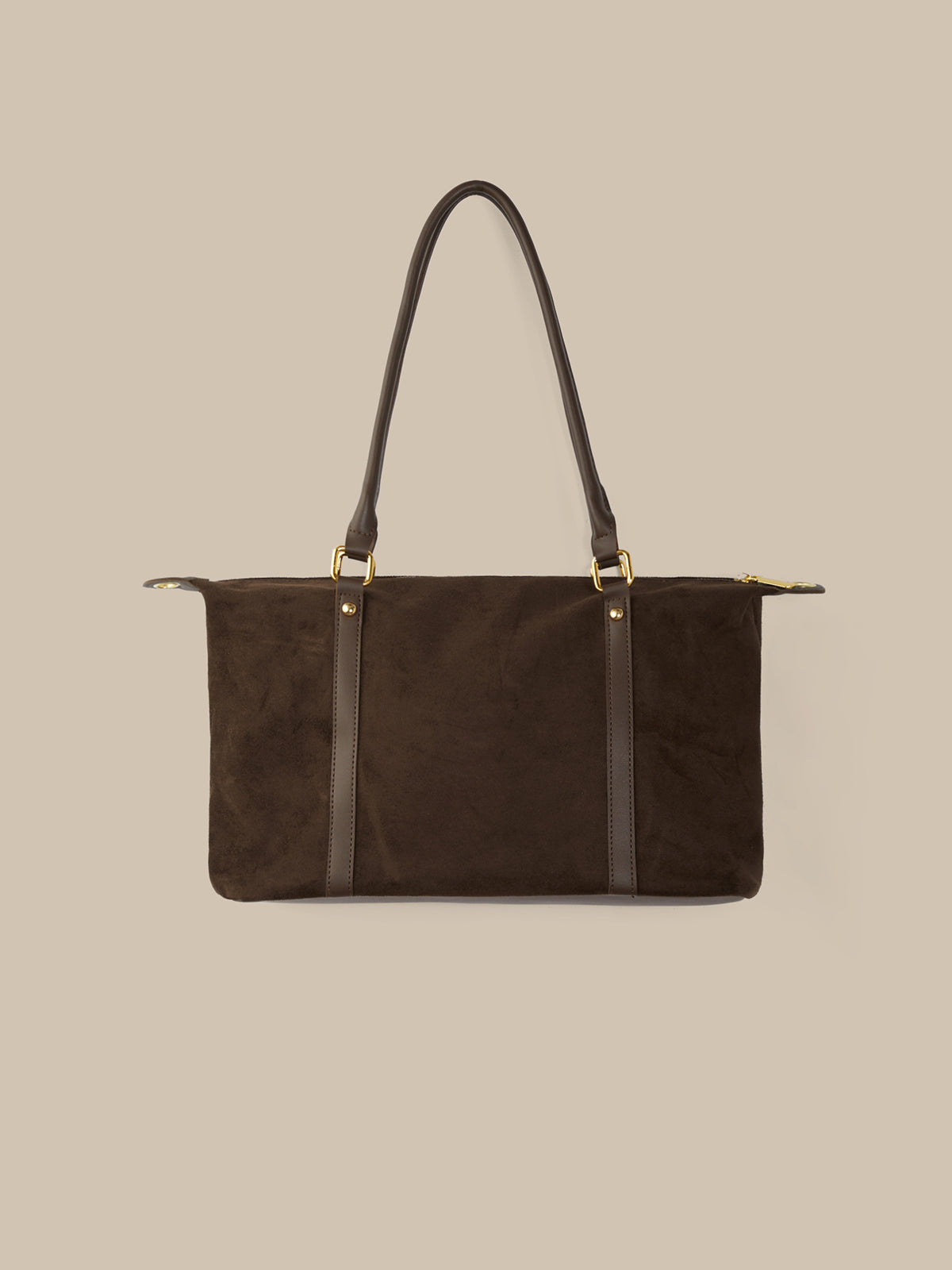 Brown handbag with black straps on a beige background