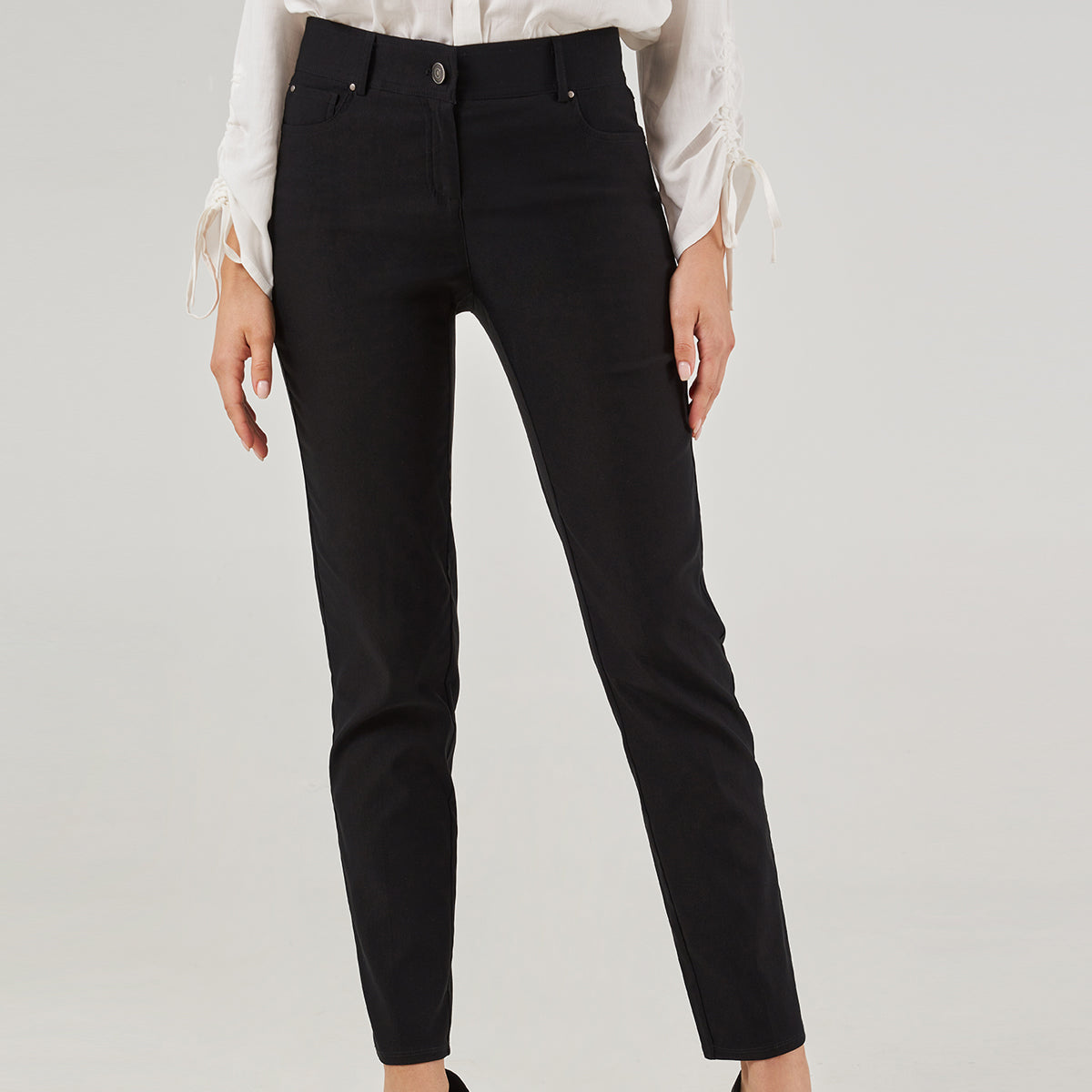 A pair of black straight leg pants with a button and zipper fly, belt loops, and five pockets.