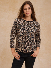 Woman wearing a leopard print top against a beige background