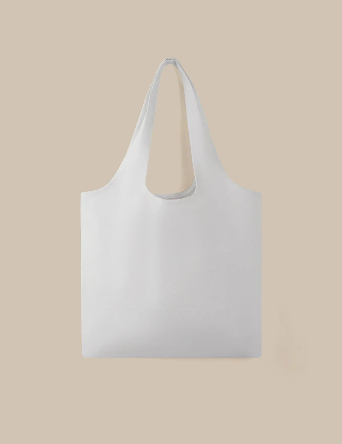 White tote bag on a beige background
