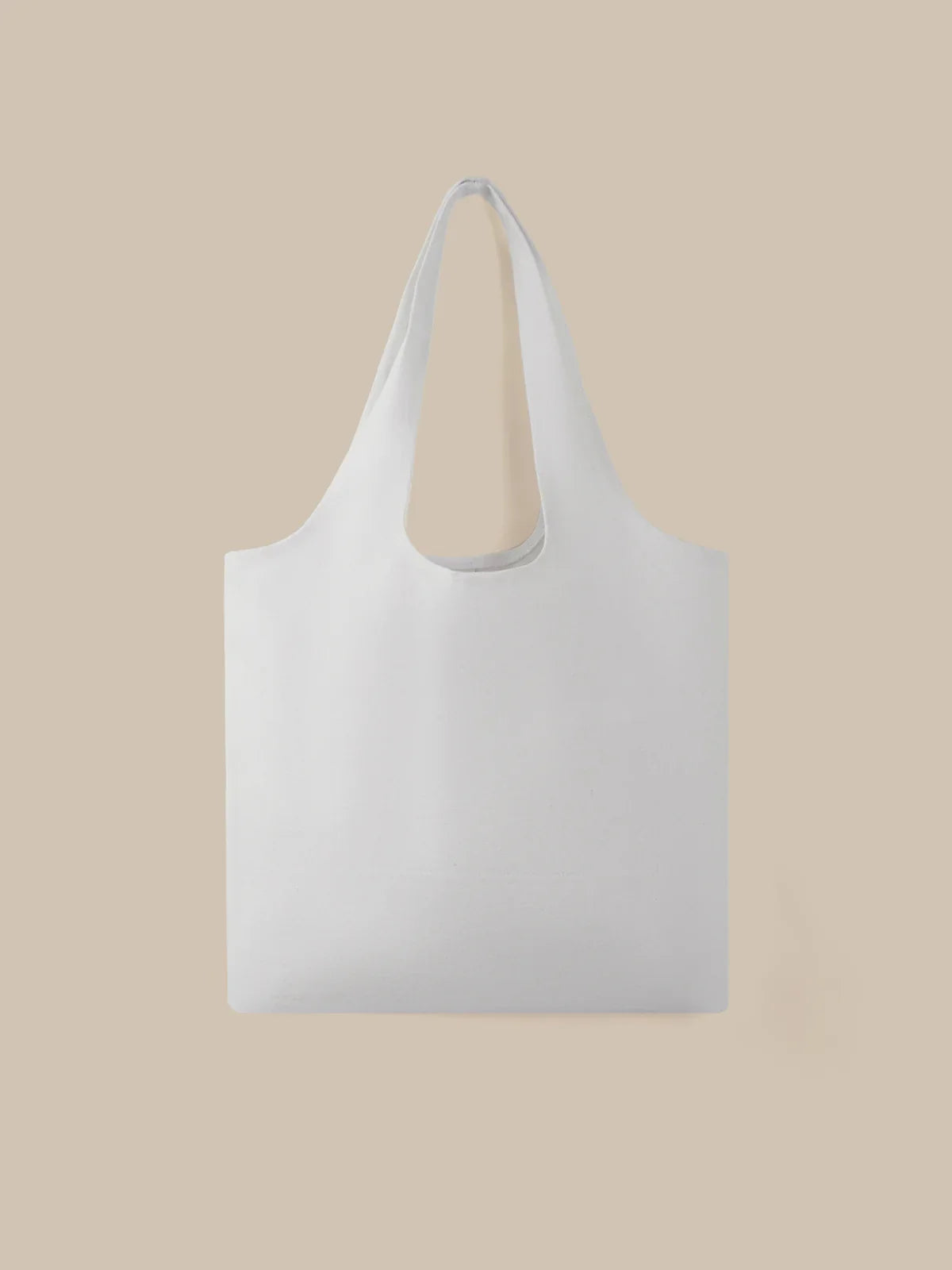 White tote bag on a beige background