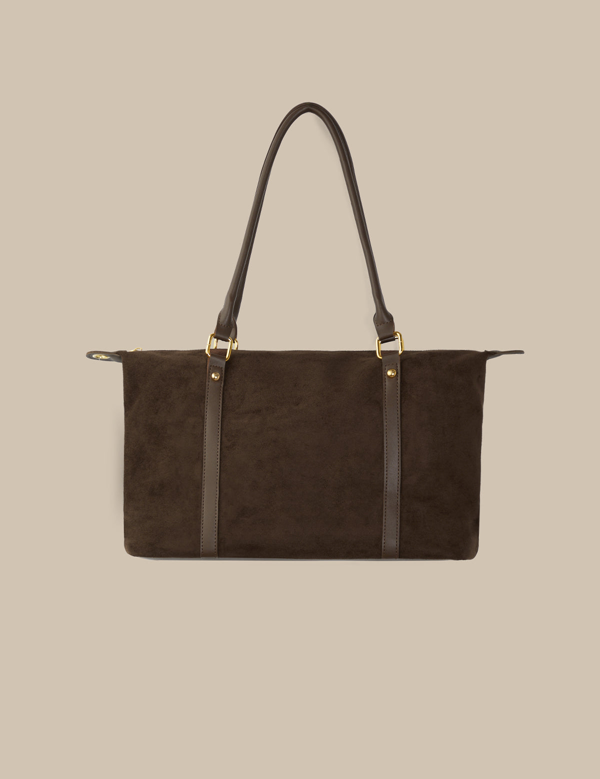 Brown leather handbag with black straps on a beige background