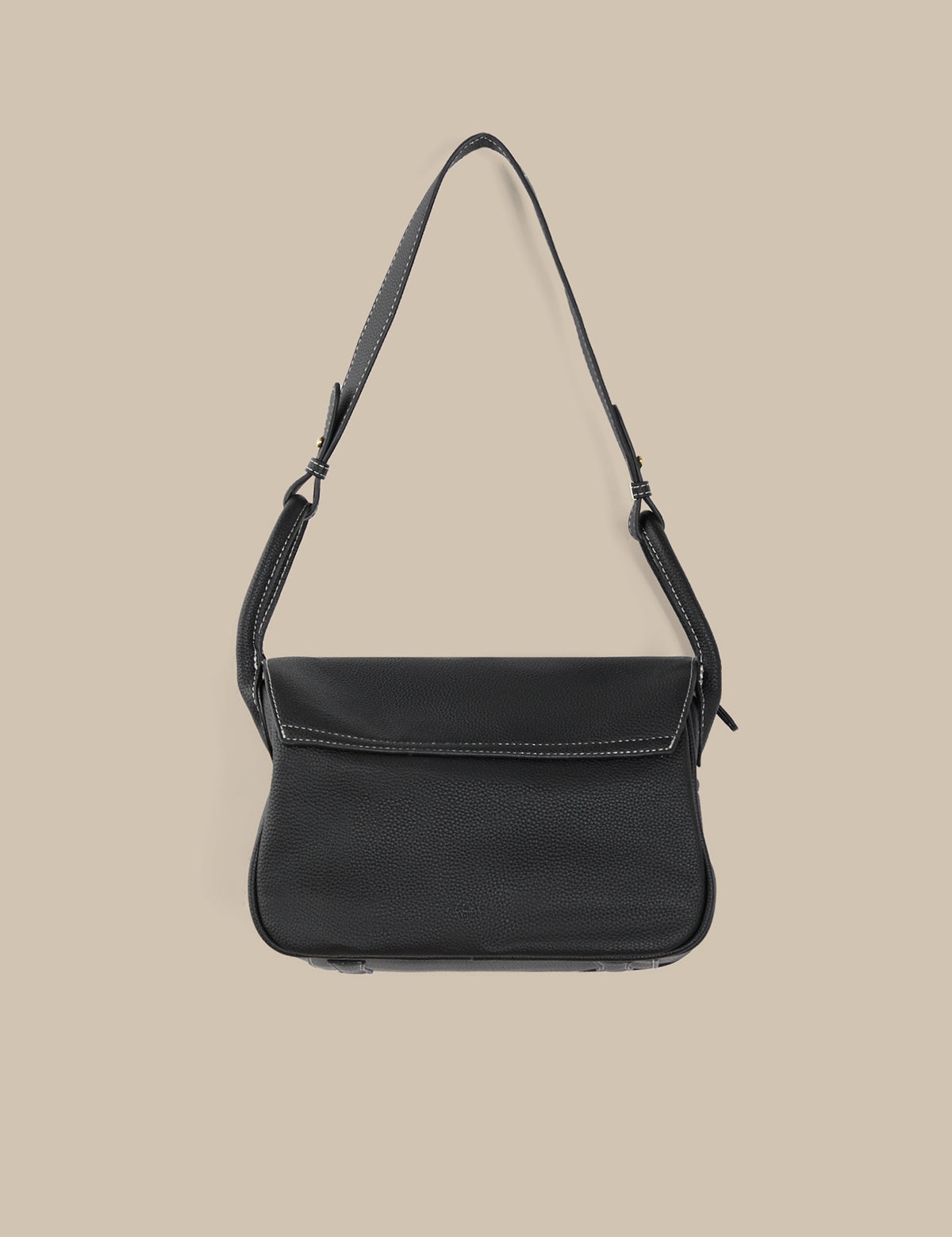 Black shoulder bag on a beige background
