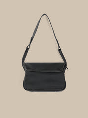 Black shoulder bag on a beige background