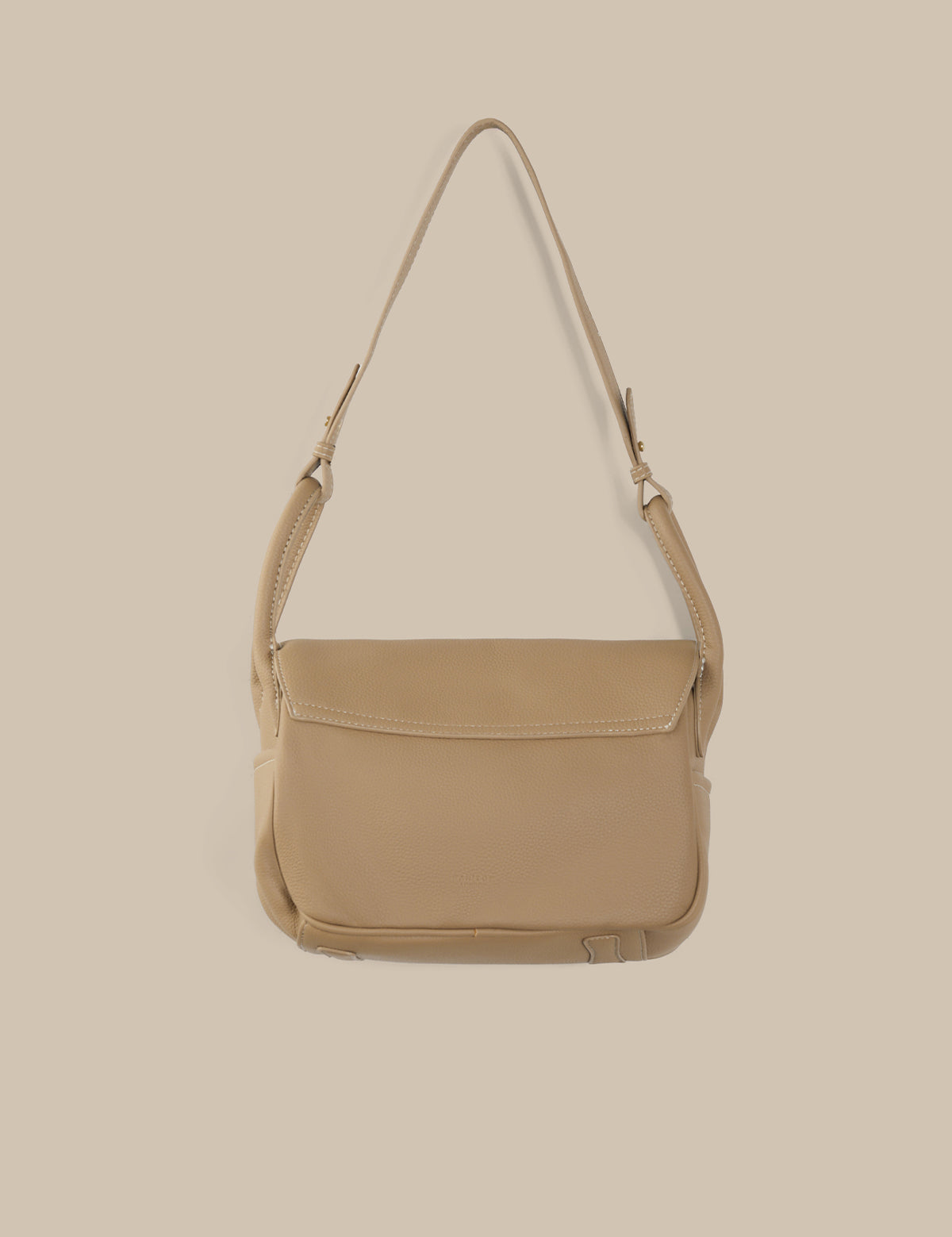 Beige shoulder bag on a beige background