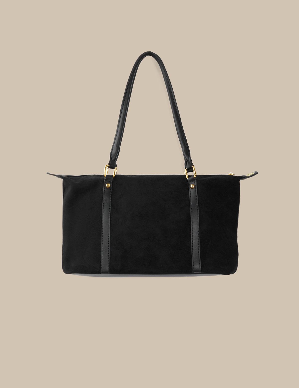 Black handbag with gold hardware on a beige background