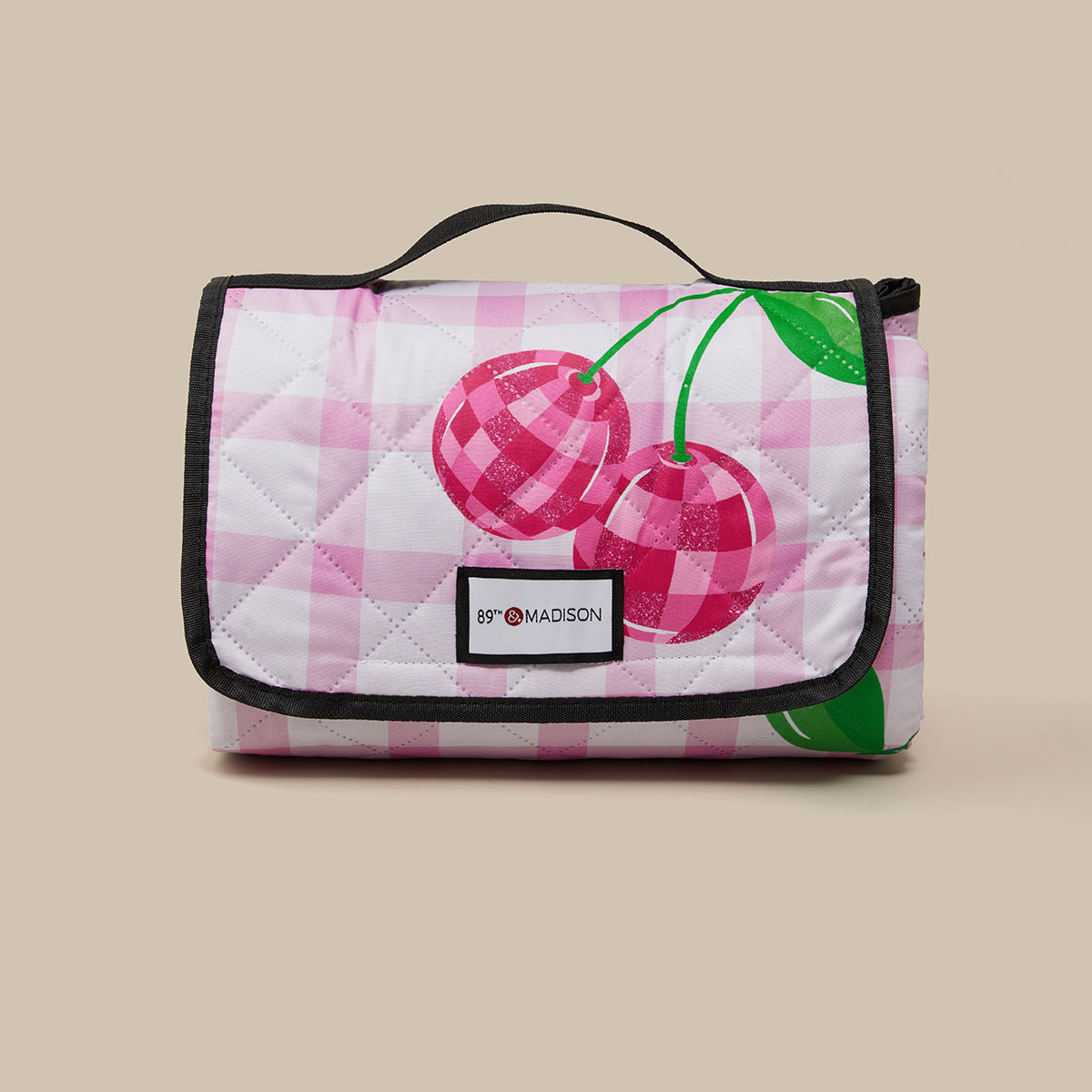 Quilted bag with cherry design on a beige background