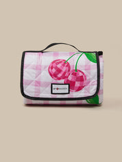 Quilted bag with cherry design on a beige background