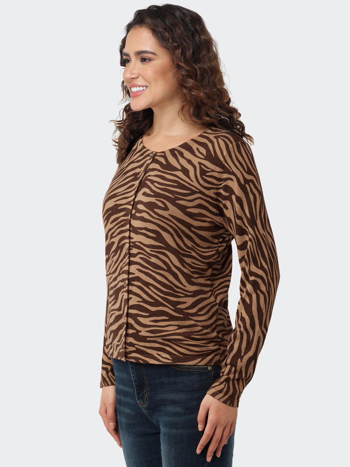 Woman wearing a brown and black zebra print long-sleeve cardigan on a white background