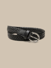 Black braided belt with a silver buckle on a beige background