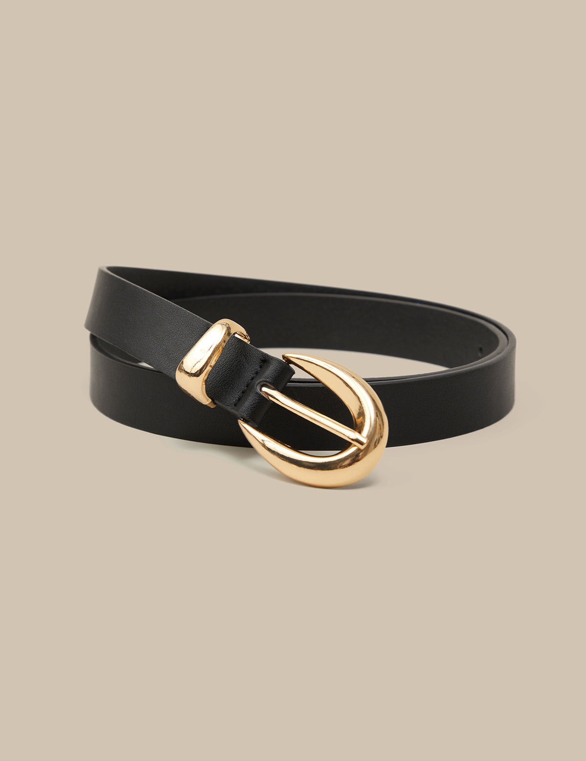 Black belt with a gold buckle on a beige background