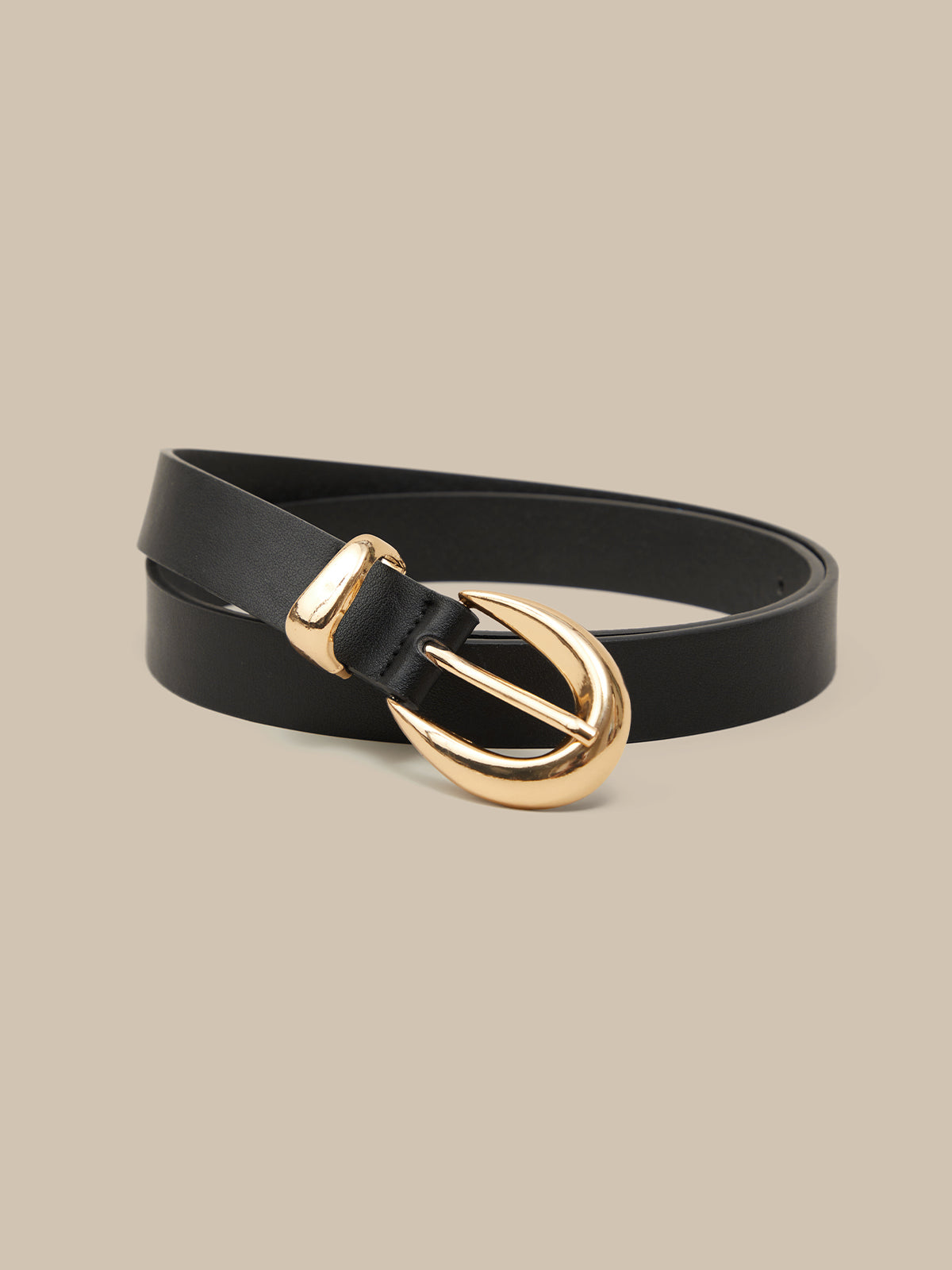 Black belt with a gold buckle on a beige background