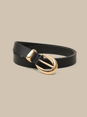 Black belt with a gold buckle on a beige background