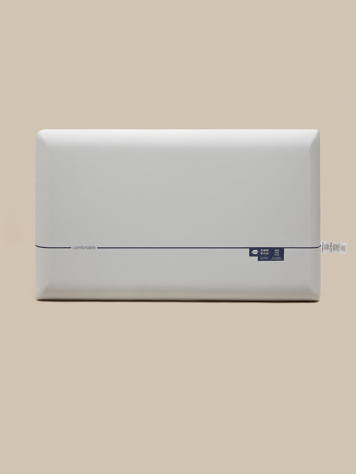 A white rectangular pillow shown from the front against a solid beige background.